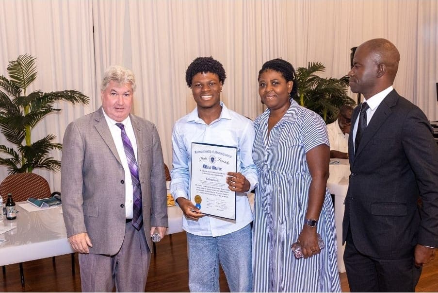 A young author holds his Official Citation after the presentation.
