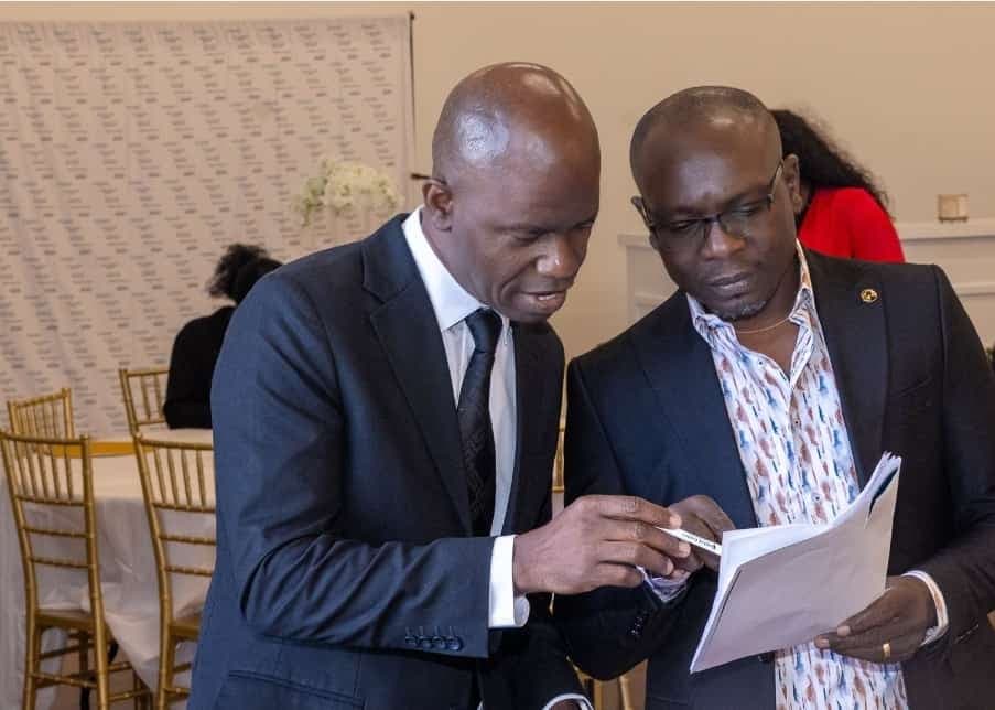 Charles Awodu reviews the program with a guest.