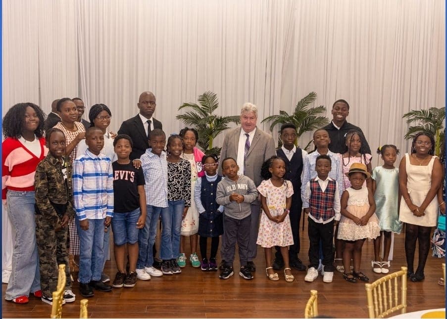Senator Michael Brady and Charles Awodu with children at the recognition.