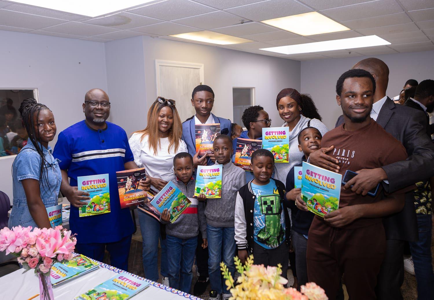 Young authors and supporters with books