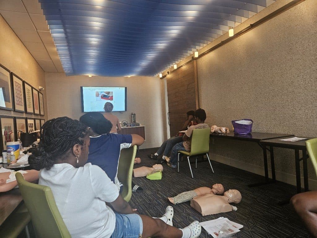 Participants watch a first aid demonstration during the life safety training
